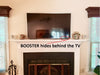 orb audio booster mini amplifier hides behind a TV